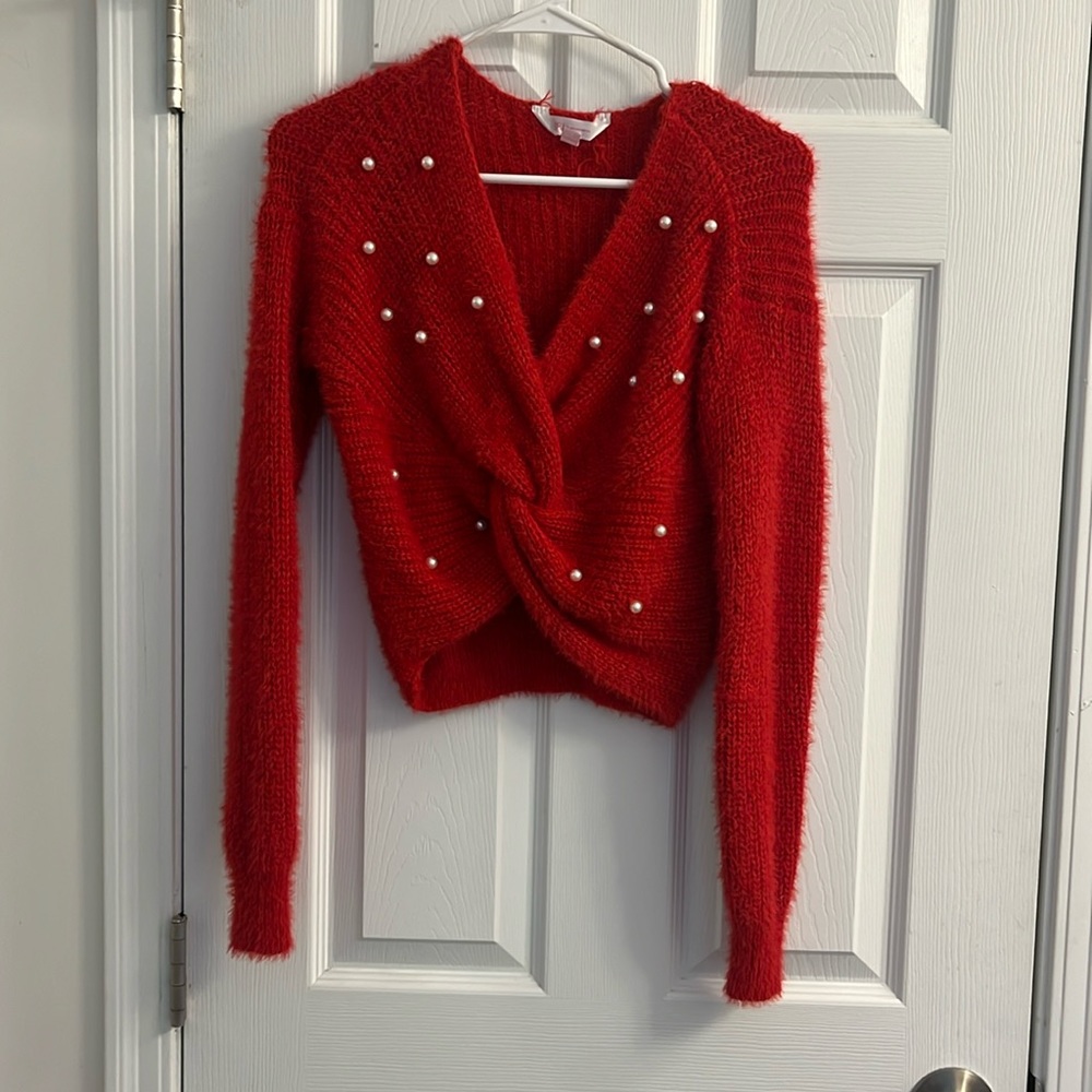 Gently worn women’s red crop top sweater with pearls.
